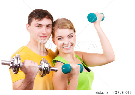 Couple exercising with dumbbells lifting weights 20226849