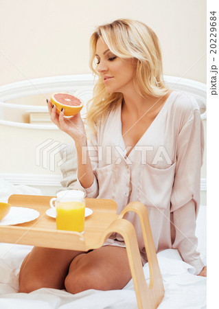 young beauty blond woman having breakfast in bed 20229684