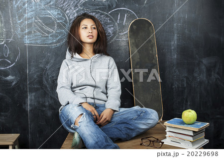 young cute teenage girl in classroom at blackboard 20229698