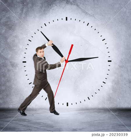 Businessman holding clock hand 20230339
