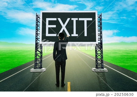 businessman standing on road and pointing with large sign of exi 20250630