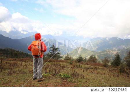 young determined woman backpacker hiking on mountain peak young determined woman backpacker hiking on mountain peak 20257486