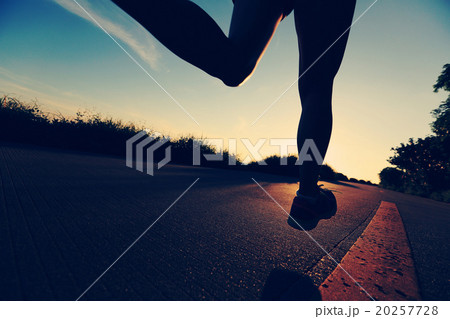 young fitness woman running on sunrise seaside trail young fitness woman running on sunrise seaside trail 20257728