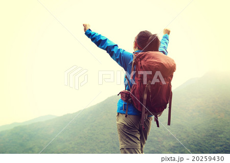 young woman hiker hiking at mountain peak young woman hiker hiking at mountain peak 20259430