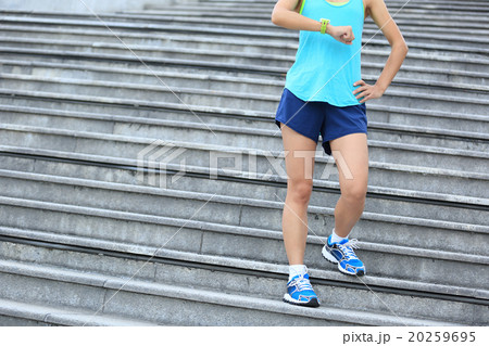 young fitness woman runner looking at her sports watch 20259695