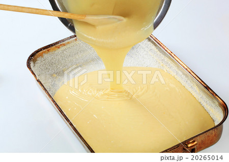 pouring batter into baking pan 20265014