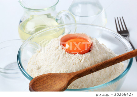 white flour with egg and wooden spoon white flour with egg and wooden spoon 20266427