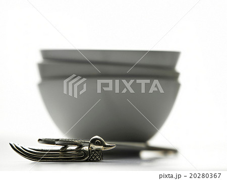 Chopsticks and stacks of white bowls 20280367