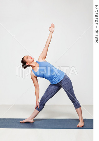 Woman doing yoga asana utthita trikonasana 20292174