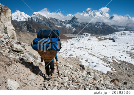 Mt.Everest and a porter at Renjo mountain pass. 20292536