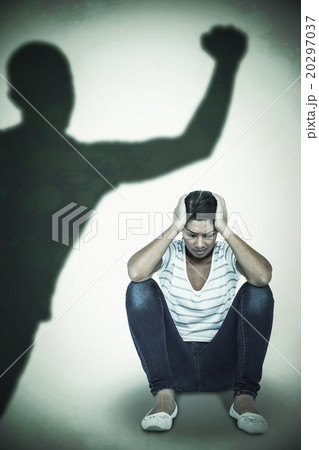 Composite image of depressed woman crouching on white background Composite image of depressed woman crouching on white background 20297037