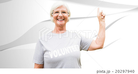 Composite image of happy volunteer grandmother with thumbs up 20297940