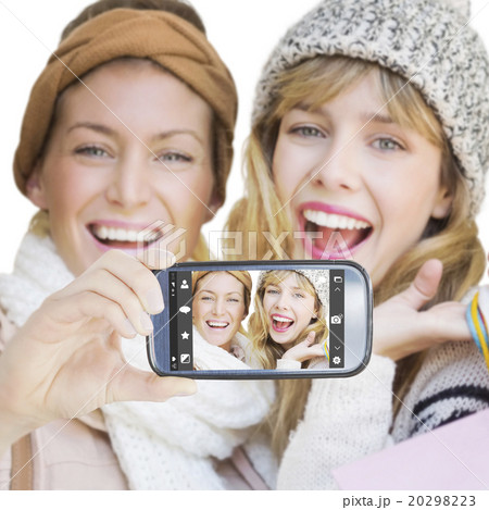 Composite image of hand holding smartphone showing Composite image of hand holding smartphone showing 20298223