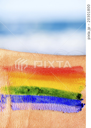 man with a rainbow flag painted in his wrist man with a rainbow flag painted in his wrist 20301800