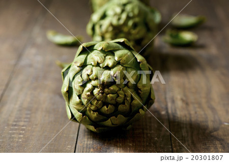 raw artichokes on a wooden surface 20301807
