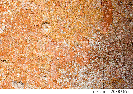 Concrete surface with the remains of orange paint  20302652
