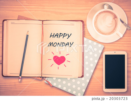 Happy Monday on notebook and coffee cup  20303723