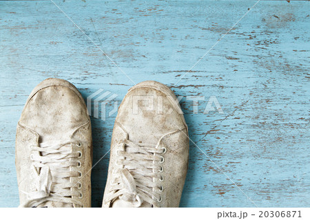 White dirty shoe on wooden floor. 20306871