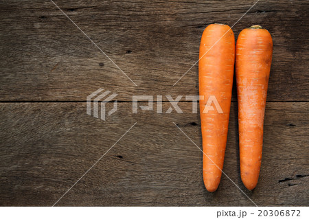 Fresh carrots on wooden background. 20306872
