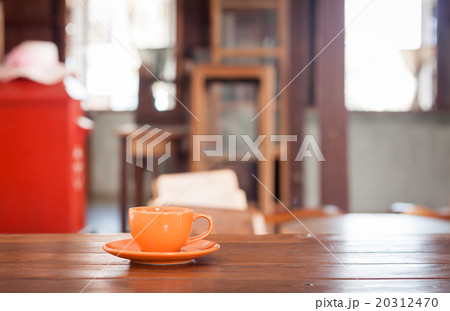 Orange coffee cup on wooden table 20312470