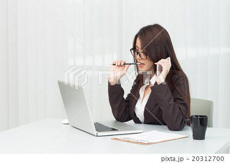 Businesswoman using laptop at office 20312700