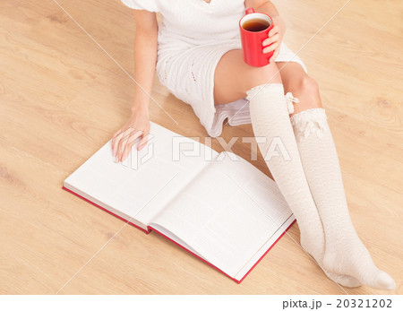 Lady with a cup of tea indoors Lady with a cup of tea indoors 20321202