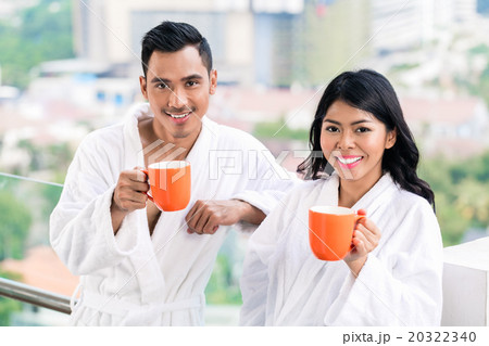 Asian couple in morning front of city skyline Asian couple in morning front of city skyline 20322340