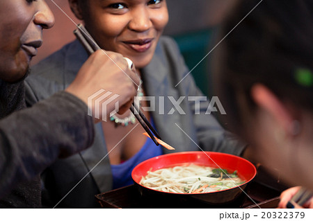 Friends eating noodle soup in Japanese Restaurant 20322379