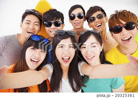 group of smiling friends with camera  taking self photo 20325361