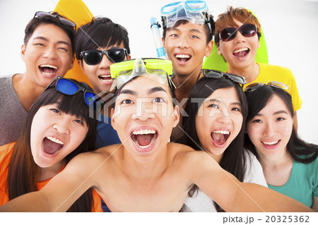 group of smiling friends with camera taking self photo group of smiling friends with camera taking self photo 20325362