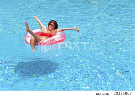 happy Young woman relaxing in swimming pool 20325967