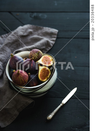 Rustic metal bowl of fresh figs on dark background 20336488