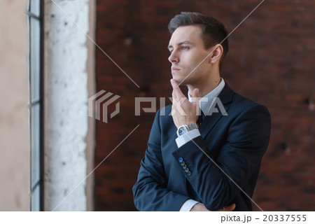Portrait of a businessman looking at the window. Portrait of a businessman looking at the window. 20337555