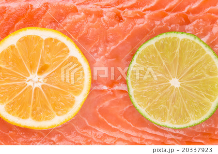Lemon and lime on salmon fillet. Macro. Lemon and lime on salmon fillet. Macro. 20337923