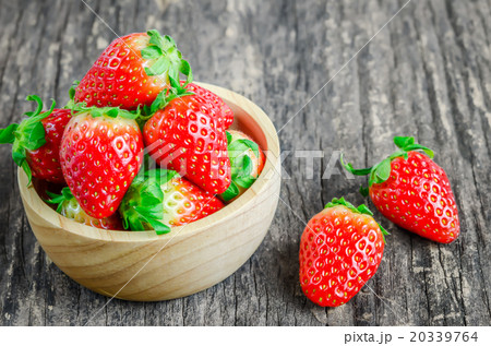 Red Strawberries in brown wooden bowl 20339764
