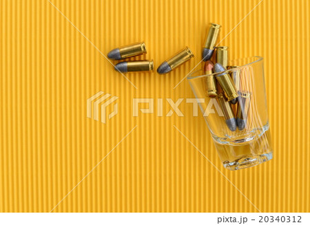 Bullets in drinking glass 20340312