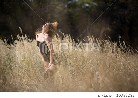 young girl with red hair in a field 20353283