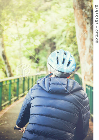 Young man cycling in the forest trail Young man cycling in the forest trail 20353670