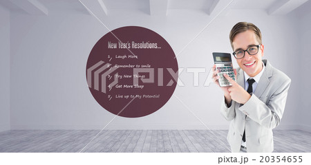 Composite image of geeky smiling businessman showing calculator 20354655