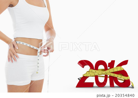 Composite image of midsection of woman measuring waist Composite image of midsection of woman measuring waist 20354840