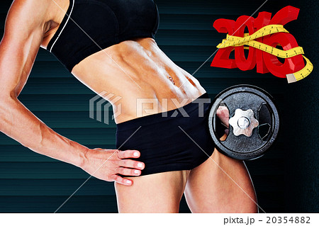 Composite image of female bodybuilder holding large black dumbbe Composite image of female bodybuilder holding large black dumbbe 20354882