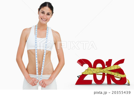 Composite image of slim woman with a measure tape 20355439