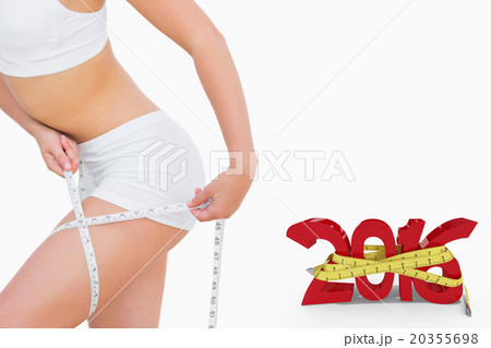 Composite image of slim woman measuring thigh with tape measure Composite image of slim woman measuring thigh with tape measure 20355698