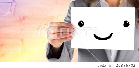 Composite image of businesswoman showing a card Composite image of businesswoman showing a card 20356702