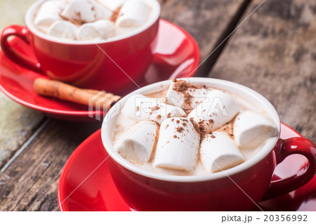 Two red cups of hot chocolate or cocoa on table 20356992