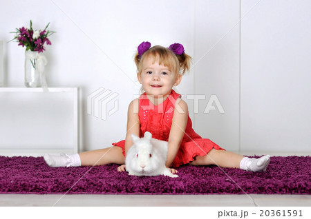 Little girl playing with white rabbit Little girl playing with white rabbit 20361591