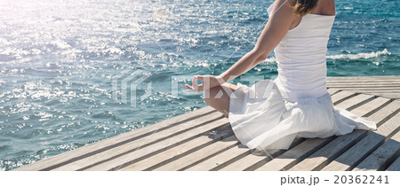 Woman meditating at the sea Woman meditating at the sea 20362241