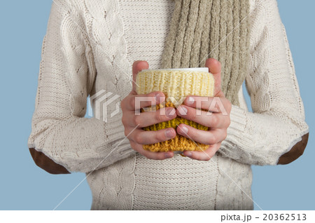 Kid's hands hold cup on blue background  20362513