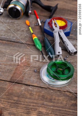 fishing tackles for anglers on wooden background 20369168
