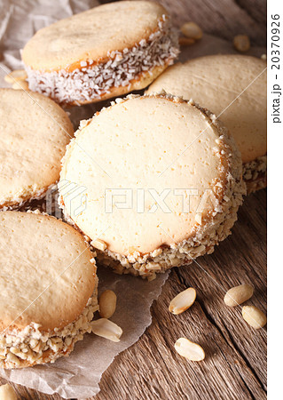 Delicious Alfajores cookies on paper close-up 20370926